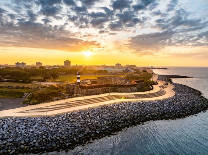 Southsea Castle with sea and rocks with sunset in background