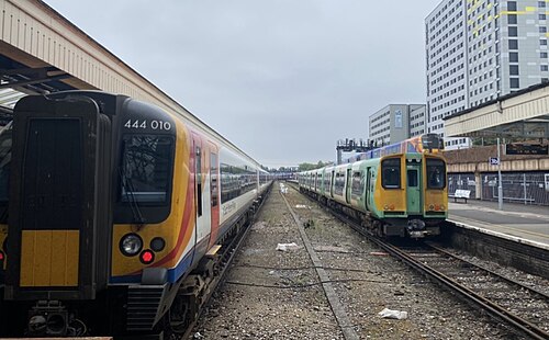 Portsmouth & Southsea Station, with a South Western Railway train and a Southern Train with a Skyscraper in the background
