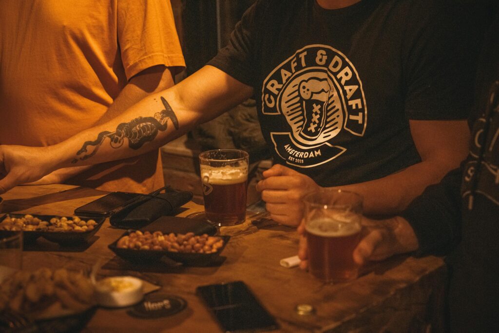 Friends enjoying craft beer and snacks indoors at a casual pub in Ankara, Türkiye. Southsea's Ultimate pub
