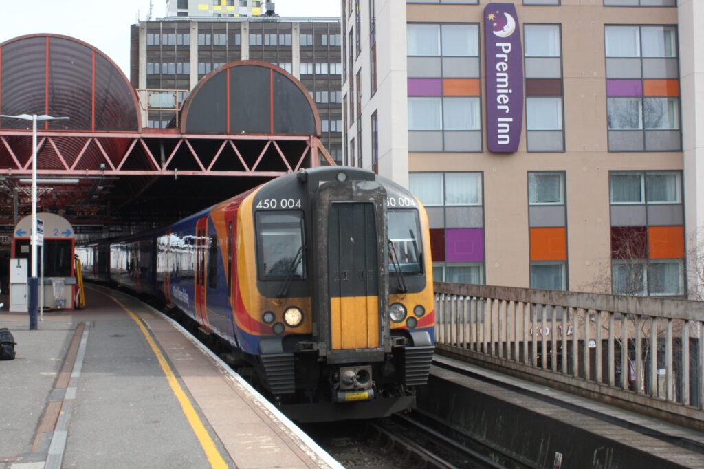 SWR Train pulled into Platform 2 of Portsmouth and Southsea Train Station, overlooking Premier Inn